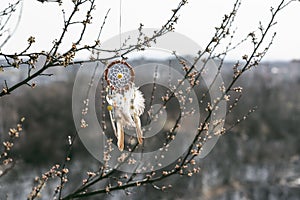 Handmade native american dream catcher on background of rocks an