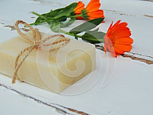 Handmade natural bath spa calendula soap on vintage wooden background. Soap making. Soap bars.
