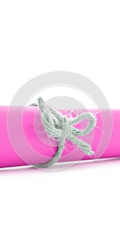 Handmade natural cord node tied on pink paper tube isolated