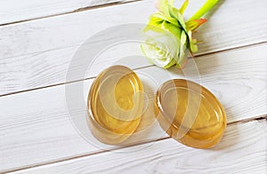 Handmade natural honey ginger soap on white wood background