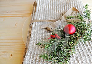 Handmade natural linen bath towel with waffle texture on wooden background. Gift.