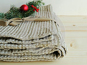 Handmade natural linen bath towel with waffle texture on wooden background. Gift.