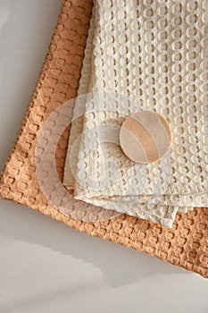 Handmade natural olive soap lies on a natural muslin towel. Composition in beige.