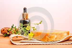Handmade natural soap on background of bottle of hyaluronic acid. Natural soap with ingredients.