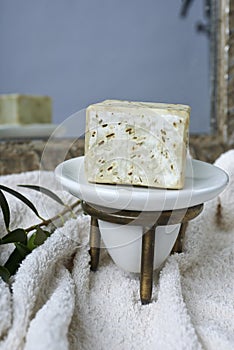 Handmade olive soap with olive branch and a towel.