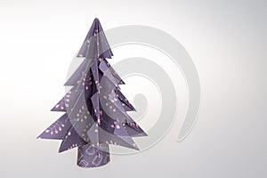 Handmade origami paper craft Christmas tree purple on paper handcraft concept  on white background