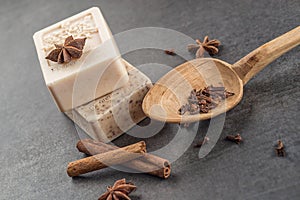 Handmade ornamental soaps with cinnamons and anise on black background, product of cosmetics and body care