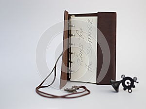 Handmade paper diary notebook in brown leather cover with over white background