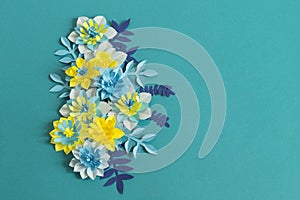 Handmade paper flowers on blue background. Favorite hobby.