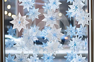 handmade paper snowflakes on a clear glass window