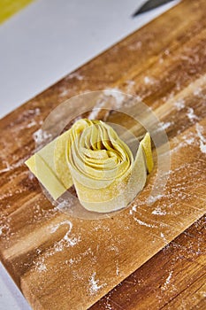 Handmade Pappardelle Egg Pasta on Rustic Wooden Board photo