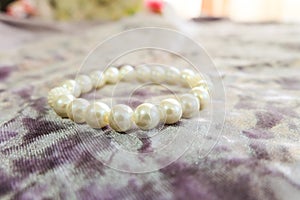 Handmade pearl bracelet on a fabric surface photo