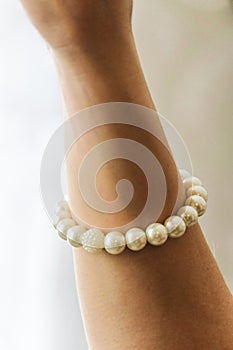 Handmade pearl bracelet on the forearm photo