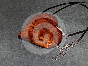 Handmade pendant with sucupira wood pendant close-up photo