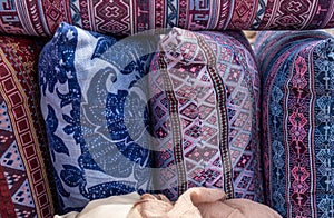Handmade pillows in colorful embroidered pillowcases for sale at local market