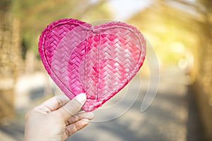 Handmade pink heart made from bamboo wood, craft object