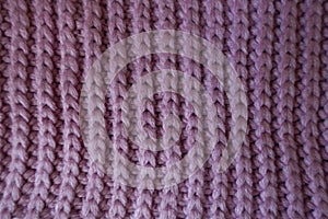 Handmade pink knitted textile with vertical ribbing pattern