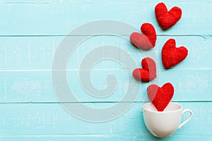 Handmade pink and red heart on blue and white color wooden background