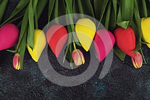 Handmade and real tulips on darken photo