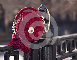 Handmade red textile knitted bag with shiny threads photo