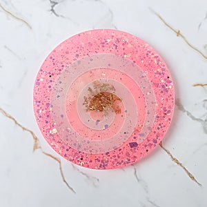 Handmade resin coaster with floral pattern on white background