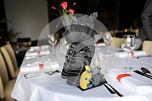 An handmade rhinoceros with two mice as part of a table decoration
