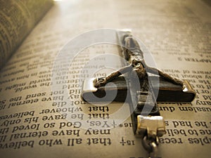 Handmade Rosary Crucific Hangs over Bible Verse from Heaven's View