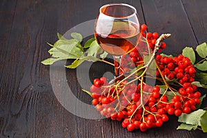 Handmade rowan-vodka and red berries of rowan tree