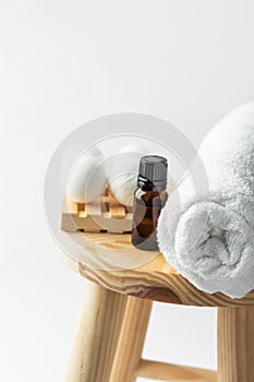 Handmade salt bath bombs in balls shape from organic vegan natural ingredients dark glass bottle with essential oil white towel