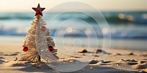 Handmade Sandy Christmas Tree with Star Topper and Red Ornaments on Tropical Beach with Ocean Background during Daytime