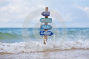 Handmade signpost on the tropical beach in