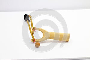 Handmade slingshot catapult. Y-shaped wooden stick with elastic tied between two top parts. Slingshot or Catapult is device for