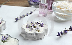 Handmade soap bar with lavender flowers in metal form on white paper