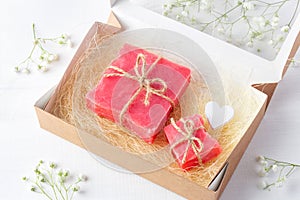 Handmade soap bars in a carton box with sisal and a wooden heart