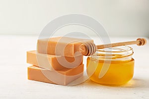 Handmade soap bars and jar of honey