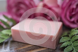 Handmade soap closeup and roses in defocus