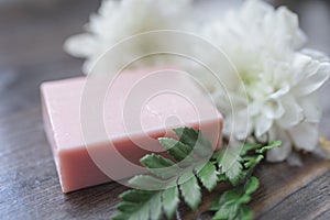 Handmade soap closeup and white flowers in defocus