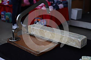 Handmade soap cutting in progress on table
