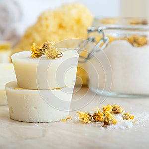 Handmade soap round bars with herbs dry marigold flowers. Spa bathroom products aroma salt, natural washcloth on marble