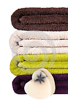 Handmade soap and stacked colorful towels