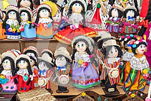 Handmade souvenir dolls in the traditional embroidered clothes, province of Azuay. Ecuador.