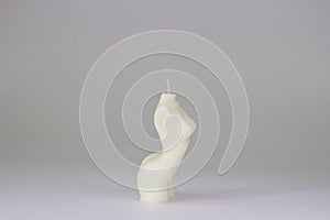 Handmade soy wax candle on white background. Naked woman torso candle