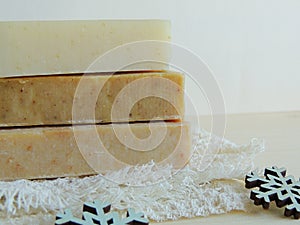 Handmade spa bath soap on white handmade linen waffle texture wash cloth, towel, wooden background.