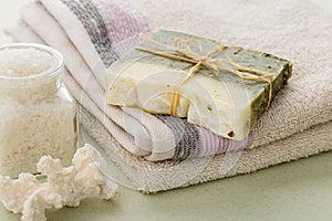 Handmade spa olive oils and dried herbs soap on towel