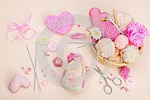Handmade spring decor concept. Creative crocheting, house figurine, traditional flowers and hearts