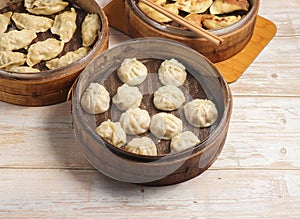 Handmade steamed dumplings and fried dumpling or momo served in wooden dish isolated on table top view Japanese food