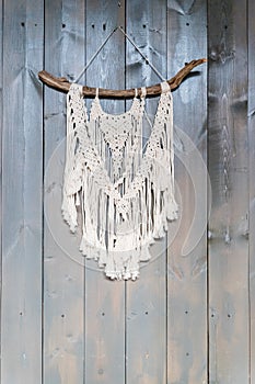 Handmade stylish cotton macrame decoration. Copy space.boho home interior decor,macrame wall hanging decoration, cozy