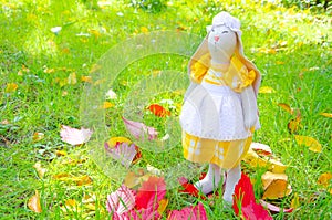 Handmade toy hare. Bunny mistress do it yourself from natural materials. Toy bunny in a dress and a hat. Decor macro