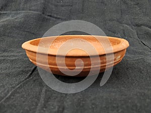 Handmade Traditional Clay or Sand Brown Color Bowl, Pot Lid  on a Black Background