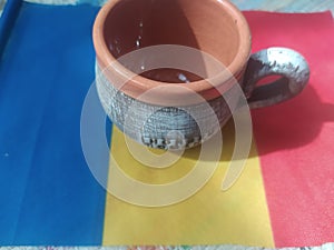 Handmade traditional Romanian objects placed on the Romanian flag and on a handmade carpet during the loom